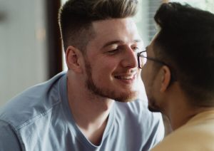 Two men staring into each other's eyes.