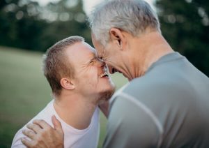 Father and son smiling at each other.