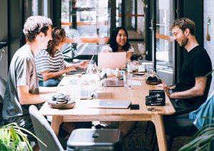 People working at shared desk.