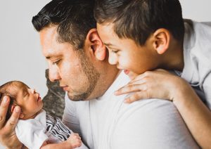 Father holding new born baby.