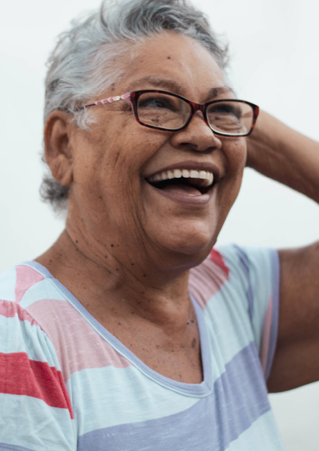 Woman smiling staring into distance.