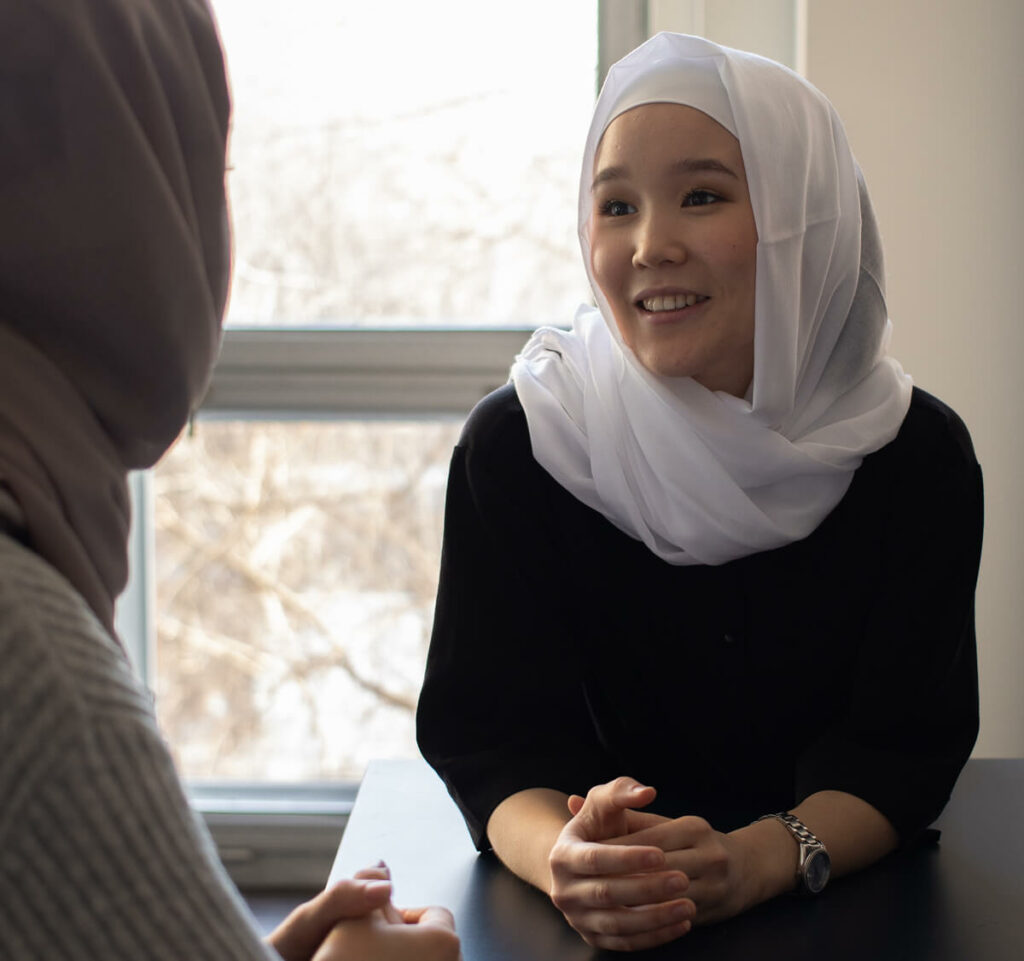 Women of Islamic faith speaking together.