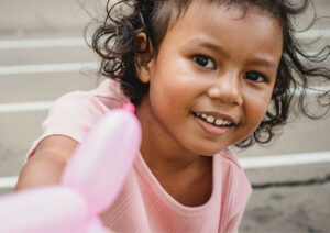 Young girl smiling to camera.