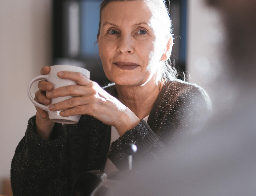 Woman holding a cup of tea.