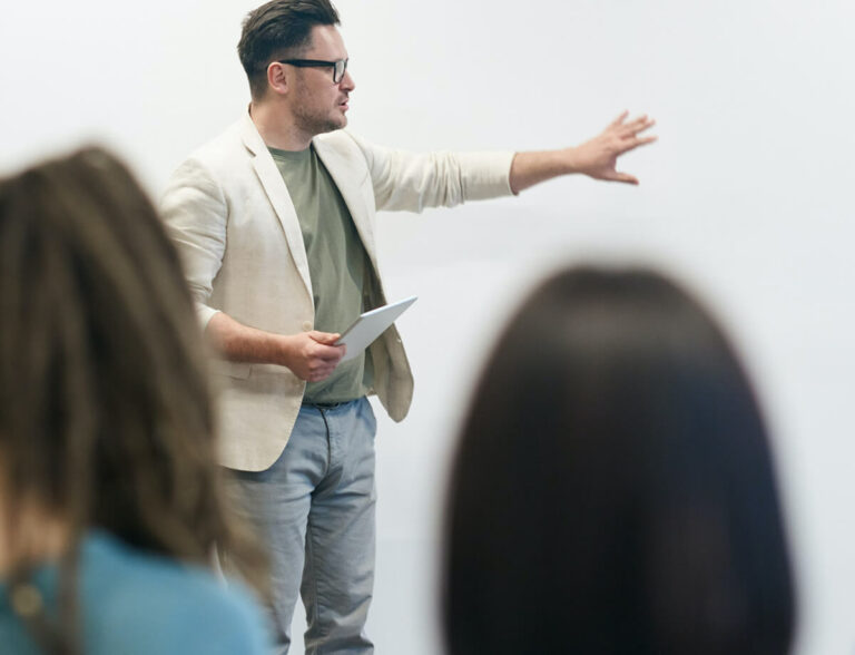 Person speaking to a group of people.