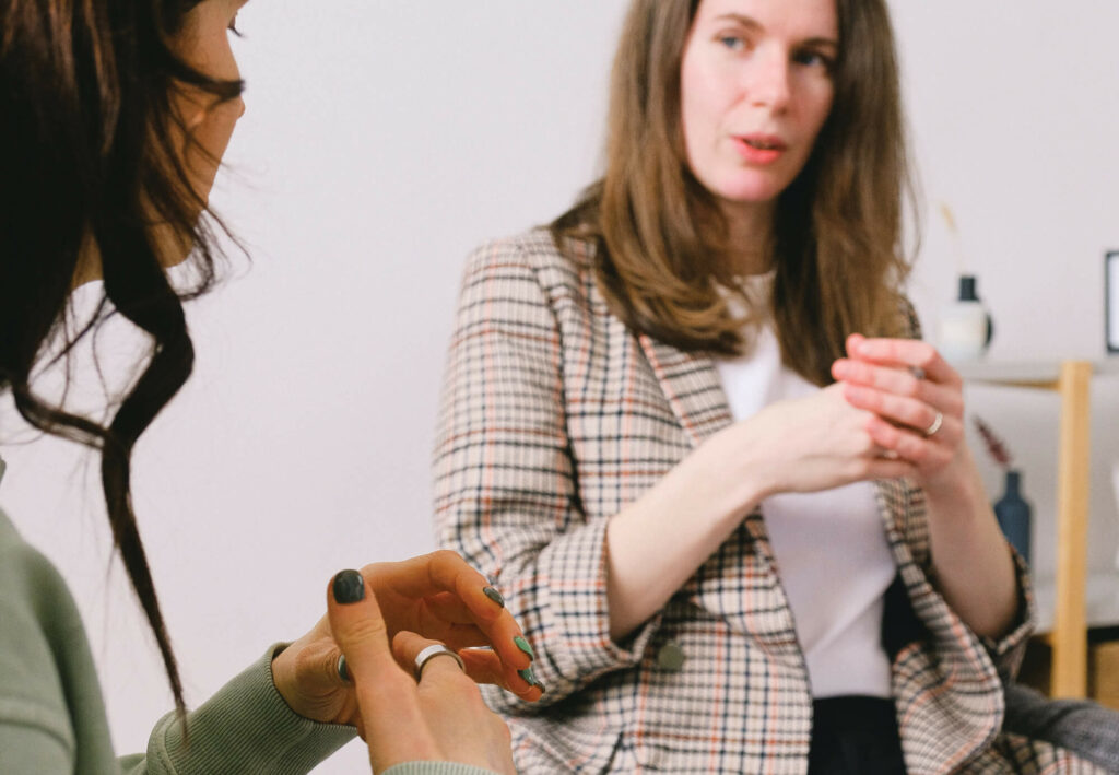 Two people talking with their hands.