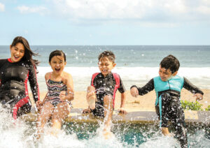 Kids splashing water at the beach.