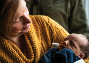 Mother holding a newborn child.