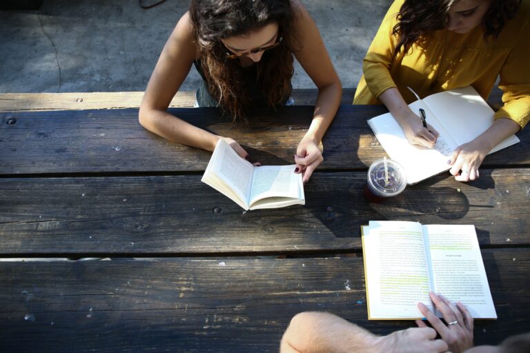 Young people sitting around a table studying.