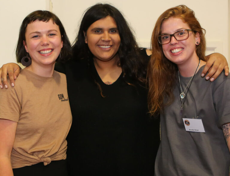 Three women together at a workshop.